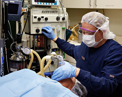 Tony Reynolds, CRNA, administering anesthesia.